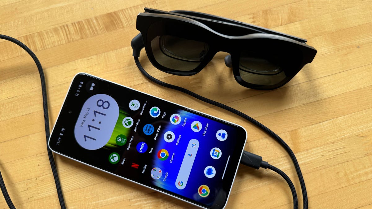 Xreal glasses plugged into the Beam Pro, a phone-like device, with screen on