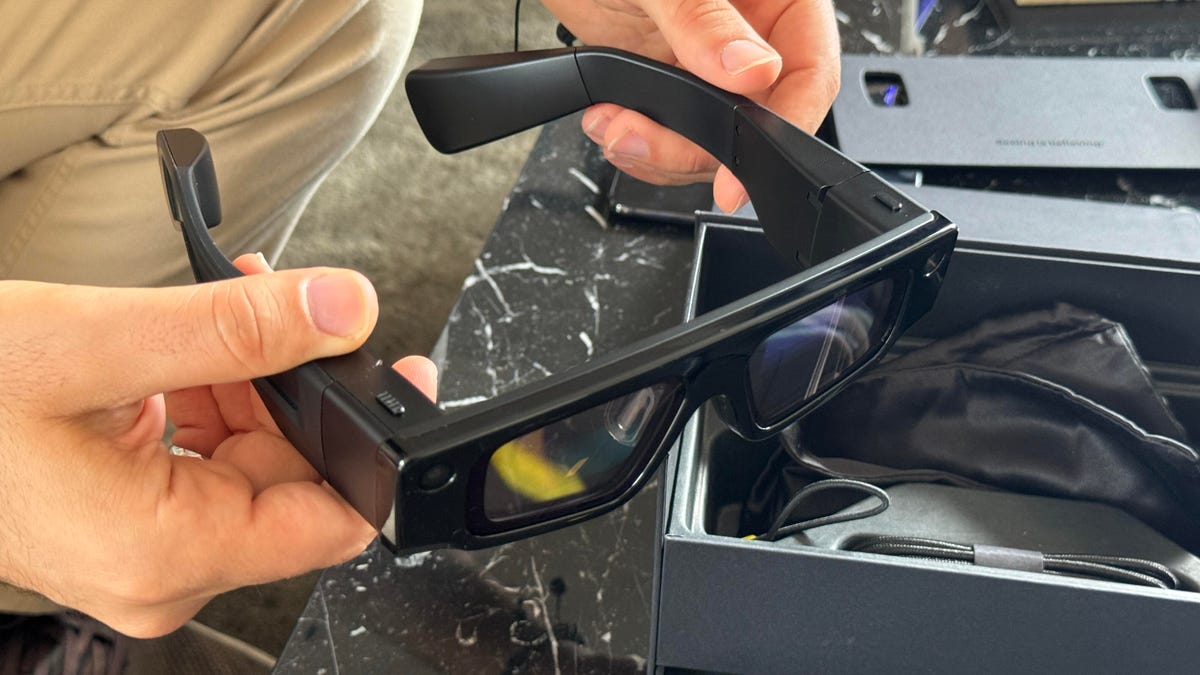 Holding thick Snap AR glasses in hands