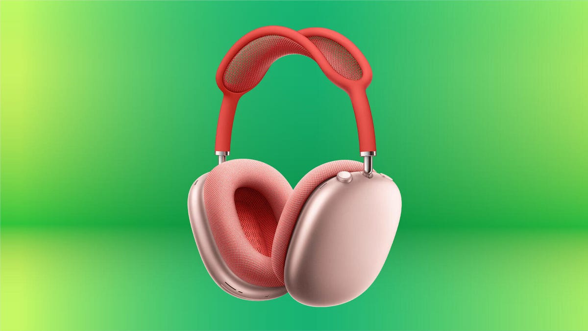 Apple AirPods Max headphones in pink against a green gradient background